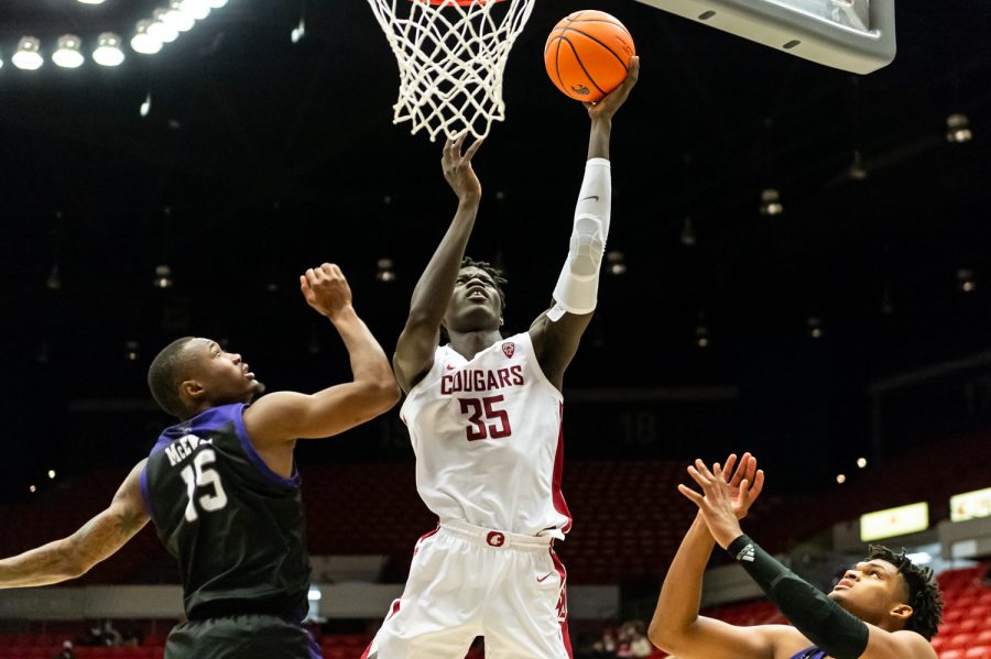 WSU forward Mouhamed Gueye (35) jumps for a layup during a college basketball game against Weber State University at Beasley Coliseum, Wednesday, Dec. 8, 2021, in Pullman, Wash.