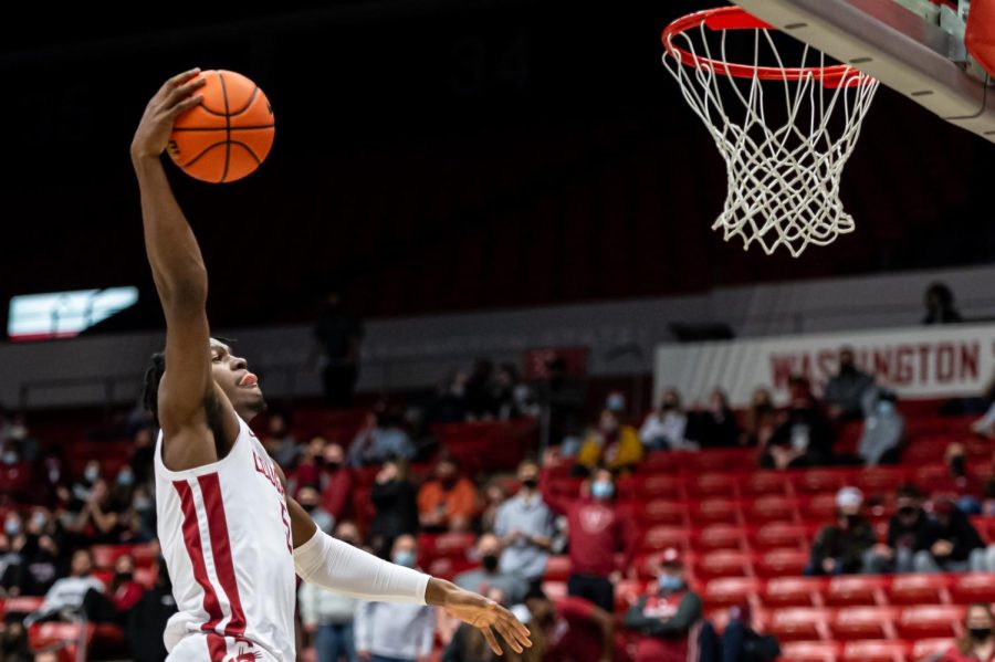 WSU guard TJ Bamba jumps into the air to dunk the ball during the first half of an NCAA college basketball game against California, Saturday, Jan. 15, in Beasley Coliseum.