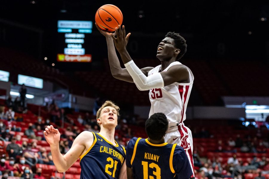 WSU forward Mouhamed Gueye (35) jumps over California forwards Lars Theimman (21) and Kuany Kuany (13) during the first half of an NCAA college basketball game, Saturday, Jan. 15, in Beasley Coliseum.