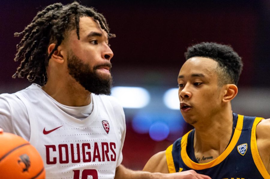 WSU guard Michael Flowers (left) dribbles the ball around California guard Jordan Shepherd (Right) during the second half of an NCAA college basketball game, Saturday, Jan. 15, in Beasley Coliseum.