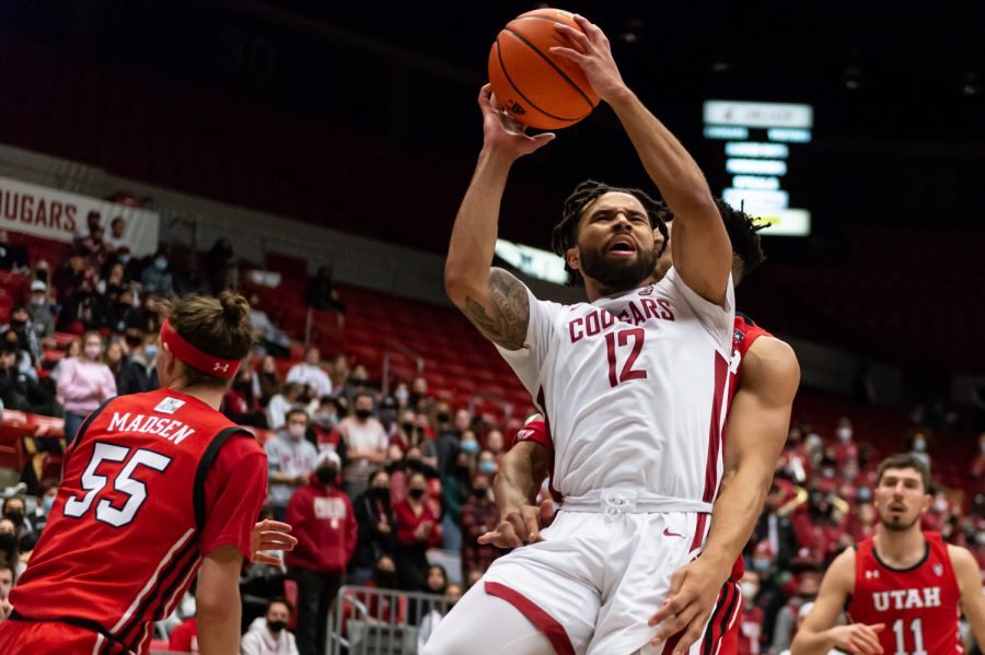 WSU guard Michael Flowers (12) is fouled by a Utah player during the second half of an NCAA collegiate basketball game, Wednesday, Jan. 26, in Beasley Coliseum.