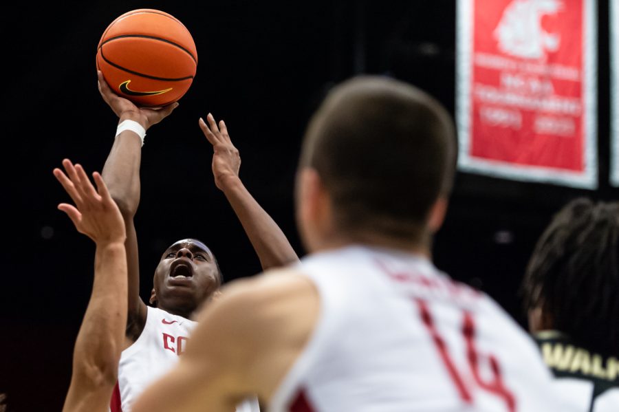 WSU guard Noah Williams (left) jumps for a layup during the first half of an NCAA collegiate basketball game against Colorado, Jan. 30, in Beasley Coliseum.