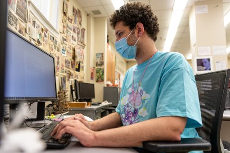 Daily Evergreen Research Editor Justin Washington works in the newsroom during a busy production day, Wednesday, Jan. 12.