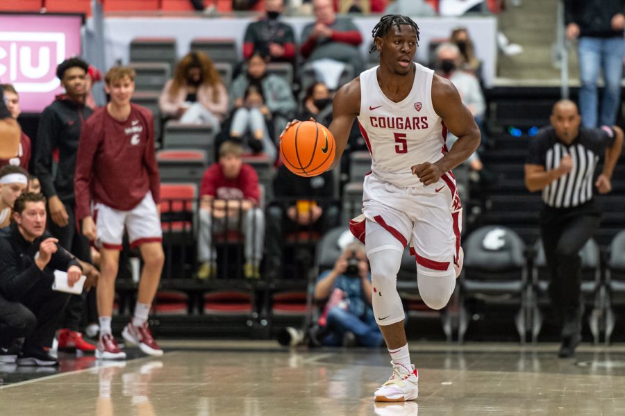 WSU guard TJ Bamba (5) dribbles down the court during the first half of an NCAA college basketball game against Stanford, Thursday, Jan. 13, in Beasley Coliseum.