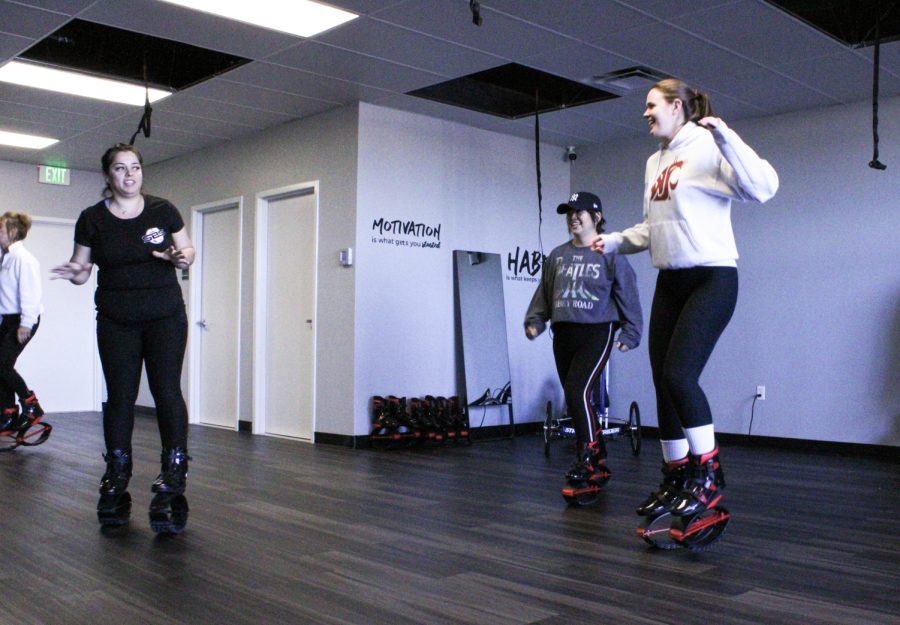Owner Crystal Gayles (left) shows participants how to use the Kangaroo bounce shoes as they warm up for their bounce fitness class on January 22, 2022,  at SBS Fitness Studio and Juice Bar.