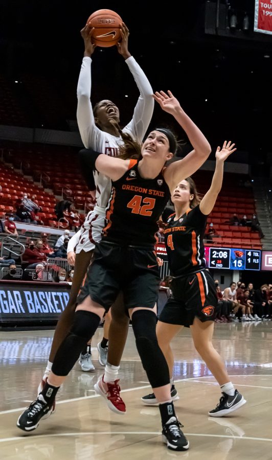 WSU center Bella Murekatete jumps over Oregon State forward Kennedy Brown for a layup during the first half of an NCAA collegiate basketball game, Wednesday, Jan. 26, in Beasley Coliseum.