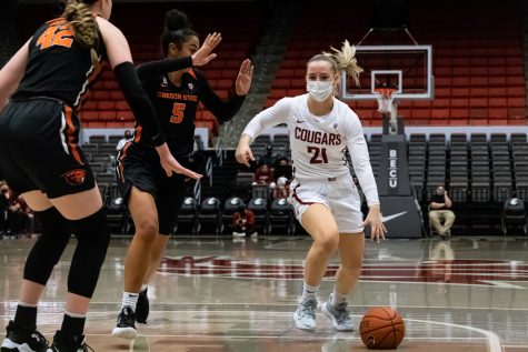 WSU guard Johanna Teder (21) dribbles past Oregon State forwards Taya Corosdale (5) and Kennedy Brown (42) during the first half of an NCAA collegiate basketball game, Wednesday, Jan. 26, in Beasley Coliseum.