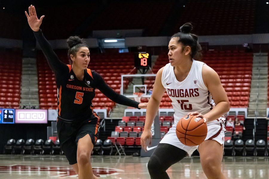 WSU forward Ula Motuga (15) attempts to dribble past Oregon State forward Taya Corosdale (5) during the second half of an NCAA collegiate basketball game, Wednesday, Jan. 26, in Beasley Coliseum.