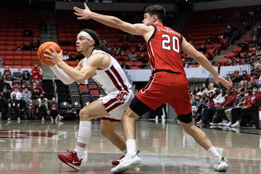 Utah guard Lazar Stefanovic (right) attempts to block a shot by WSU guard Tyrell Roberts (left) during the first half of an NCAA collegiate basketball game, Wednesday, Jan. 26, in Beasley Coliseum.