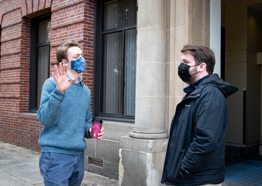 Zach Colligan and John Mccornack having a conversation with mask on outside of Carpenter, Feb. 22.