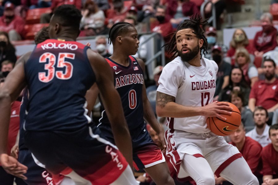 WSU guard Michael Flowers (12) finds a teammate to pass the ball to during the second half of an NCAA college basketball game against Arizona, Feb. 10.