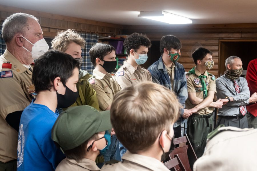 At the end of the troop meeting, after an hour of jokes, menu planning and time spent with friends, Scouts and adult leaders young and old gathered in a circle and sang Scout Vespers, Feb. 2.