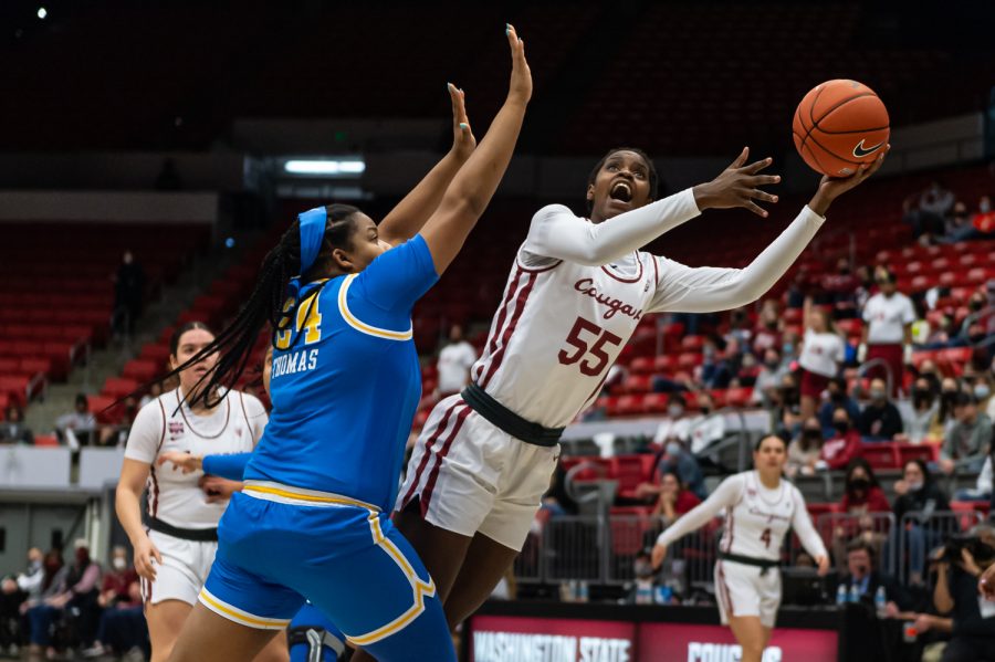 WSU center Bella Murekatete (55) jumps for a layup during the first half of an NCAA collegiate basketball game against UCLA, Feb. 11.