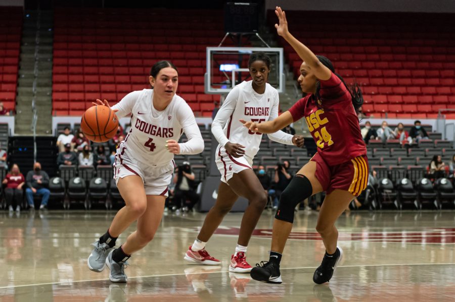 WSU guard Krystal Leger-Walker (4) dribbles around USC center Desiree Caldwell (24) during the first half of an NCAA college basketball game in Beasley Coliseum, Feb. 13.
