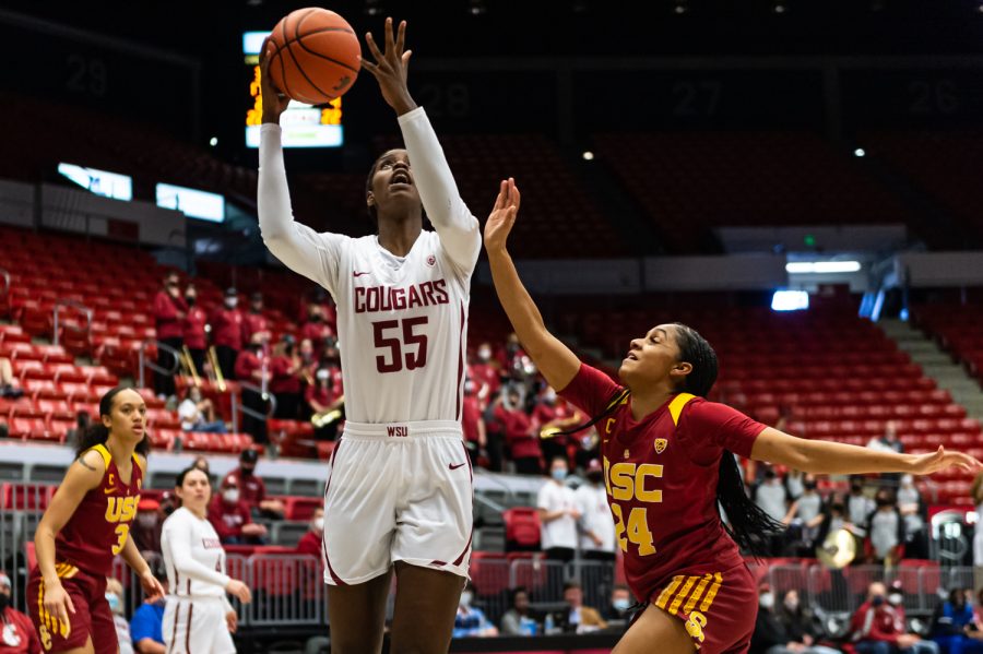 WSU guard Bella Murekatete (55) jumps over USC center Desiree Caldwell (24) for a layup during the second half of an NCAA college basketball game in Beasley Coliseum, Feb. 13.