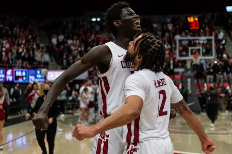WSU forward Mouhamed Gueye (left) and guard Michael Flowers (right) celebrate after defeating UW 78-70 in Beasley Coliseum, Feb. 23.