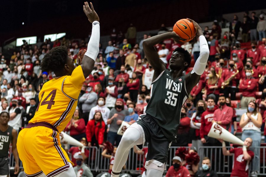 WSU forward Mouhamed Gueye (35) shoots over Arizona State center Enoch Boakye (14) during the first half of an NCAA collegiate basketball game in Beasley Coliseum, Feb. 12.