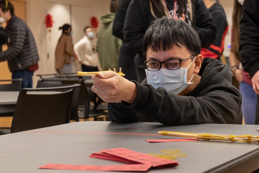 Chien Min Lee plays Knock the Bottle at the Taiwanese Student Association Lunar New Year Event, Friday, Feb. 4.