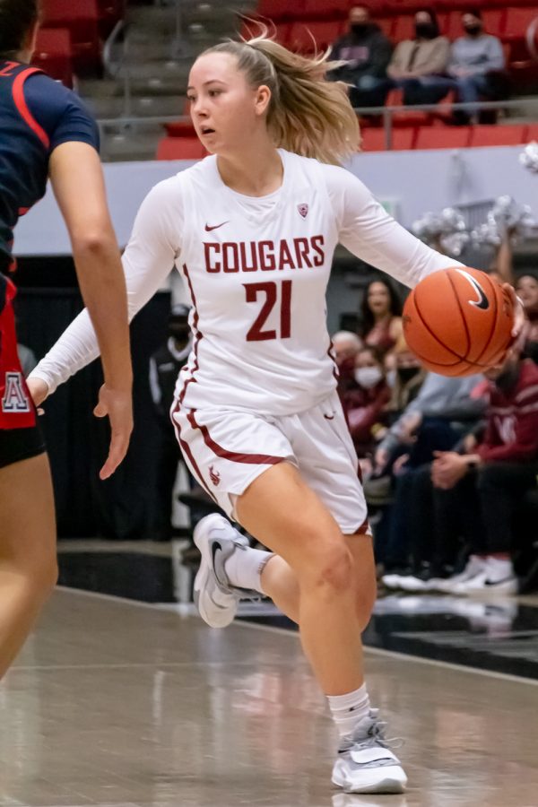 WSU guard Johanna Teder (21) dribbles the ball during the first half of an NCAA college basketball game against Arizona in Beasley Coliseum, Feb. 20.