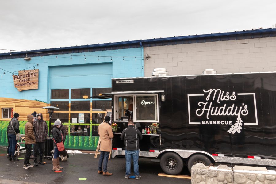Customers wait in line to order food at Miss Huddy’s Barbecue food truck, Feb. 27.