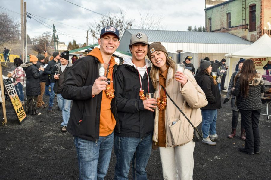 WSU students Joe Clavenna (left), Hunter Yackeren (center) and Riley Fidler (right) were some of the many visitors that made the trip from Pullman. In addition to snacks like the pretzel necklaces they are sporting, the Brew Fest offered hamburgers and hotdogs prepared by the  Palouse Lions Club. Barstow said the Lions Club will donate half of their proceeds from Saturday to the Palouse Community Center. 