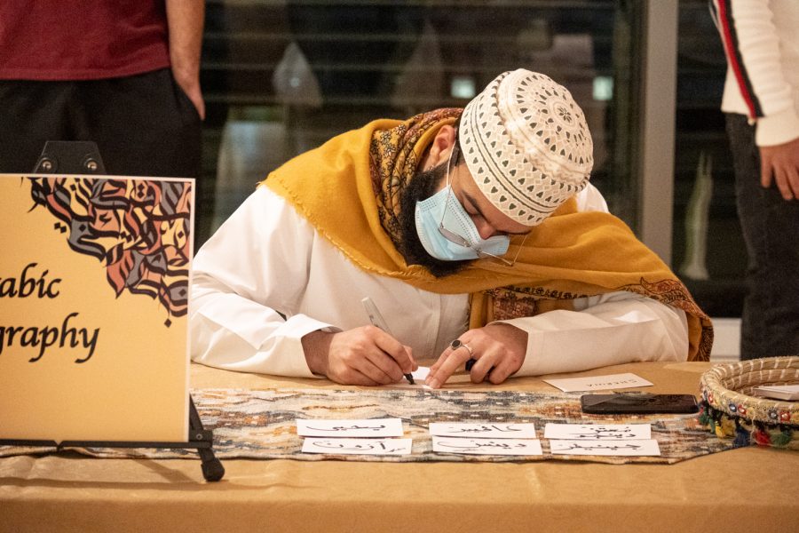 Artists draw Arabic calligraphy at the Middle Eastern Student Association cultural event, Compton Union Building, Mar. 4