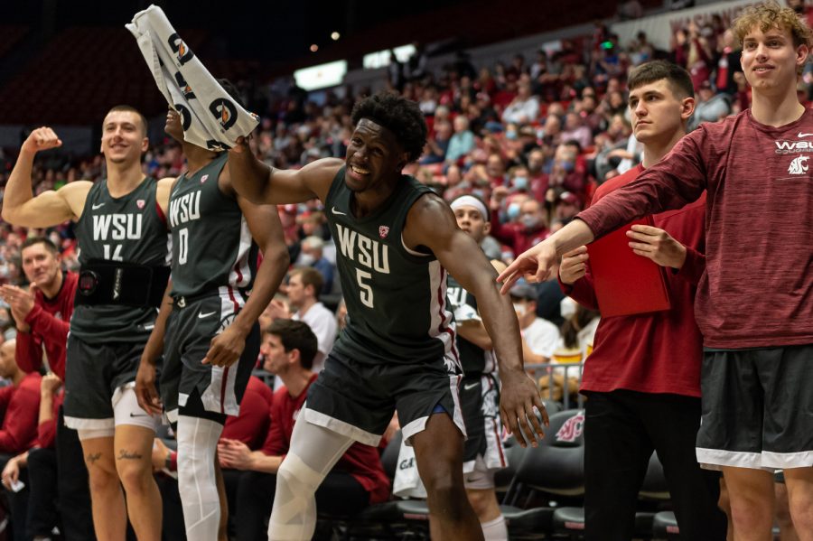 WSU players celebrate on the bench after a layup during the second half of an NCAA college basketball game against Oregon in Beasley Coliseum, March 5.