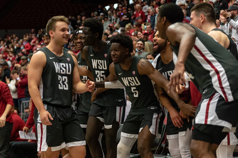 WSU players celebrate after guard Will Burghardt (33) shoots a 3-pointer  during the second half of an NCAA college basketball game against Oregon in Beasley Coliseum, March 5.
