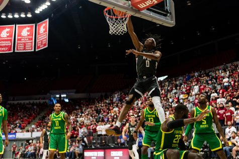 WSU forward Efe Abogidi (0) dunks the ball during the first half of an NCAA college basketball game against Oregon in Beasley Coliseum, March 5.