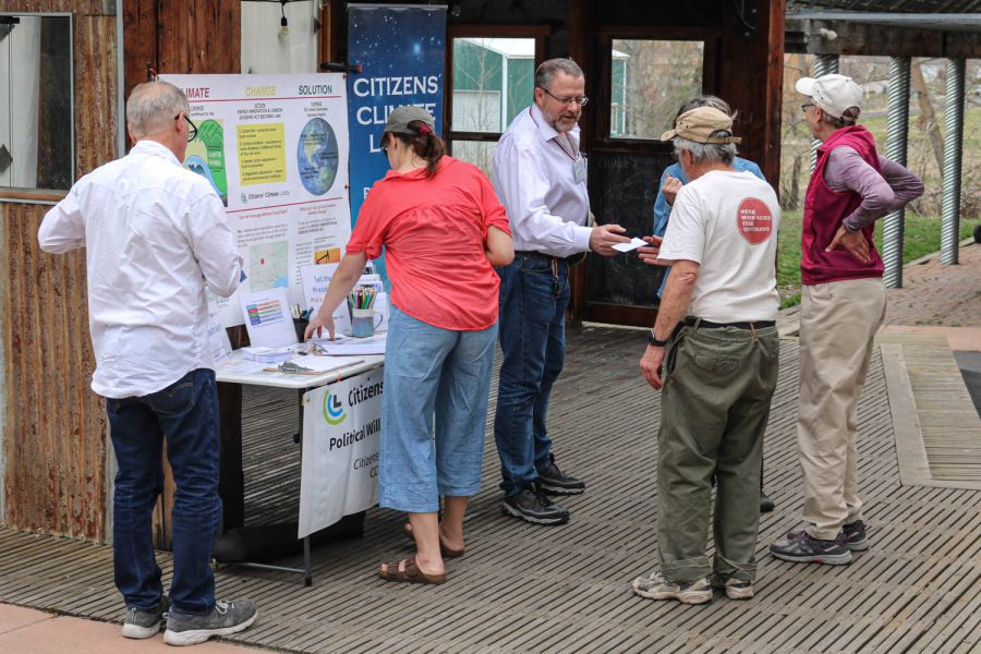 Simon Smith (center) runs the CCL table providing information and sign-ups to get involved with the  Palouse-Clearwater Environmental Institute, March 27, in Moscow.