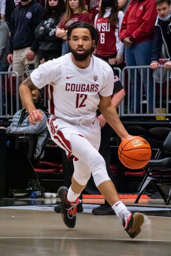 WSU guard Michael Flowers (12) dribbles the ball toward the hoop during the first half of an NCAA college basketball game against Oregon State in Beasley Coliseum, March 3.