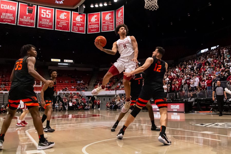 WSU forward DJ Rodman (11) jumps over Oregon State center Roman Silva (12) during the first half of an NCAA college basketball game in Beasley Coliseum, March 3.