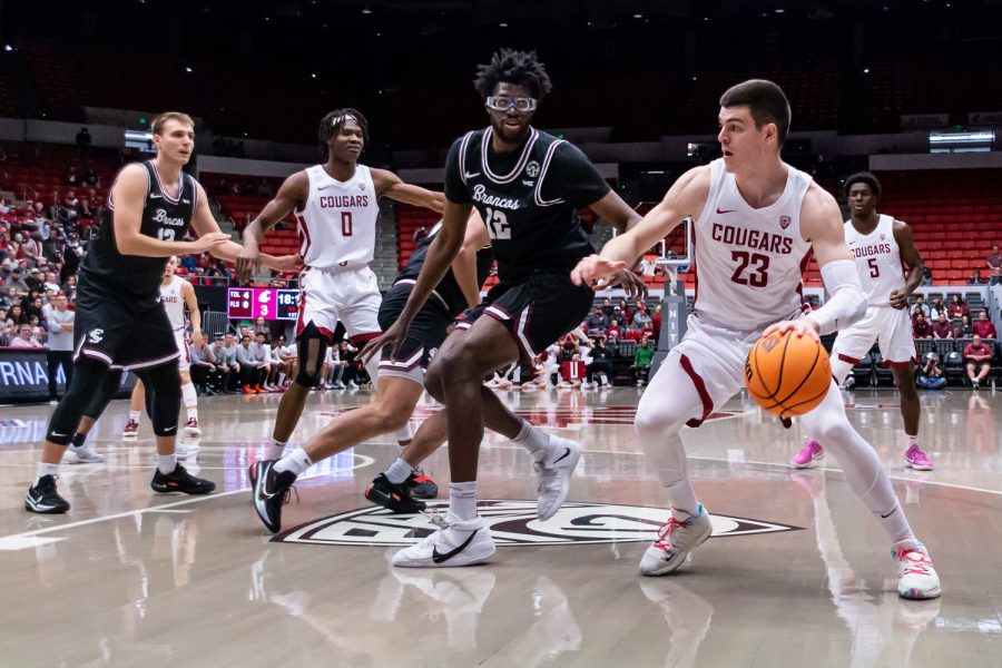WSU forward Andrej Jakimovski (23) dribbles the ball toward the hoop during the first half of an NIT first round matchup against Santa Clara, March 15, in Beasley Coliseum.