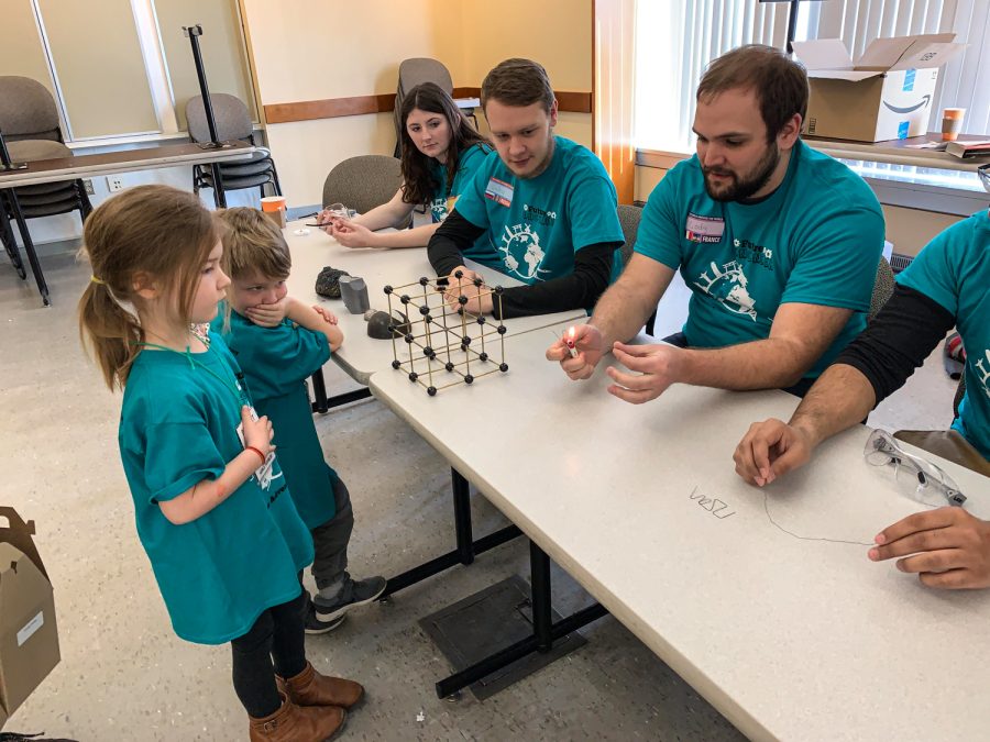Volunteers at the last in-person Kids Science and Engineering Day walk participants through a demostration in 2019. 