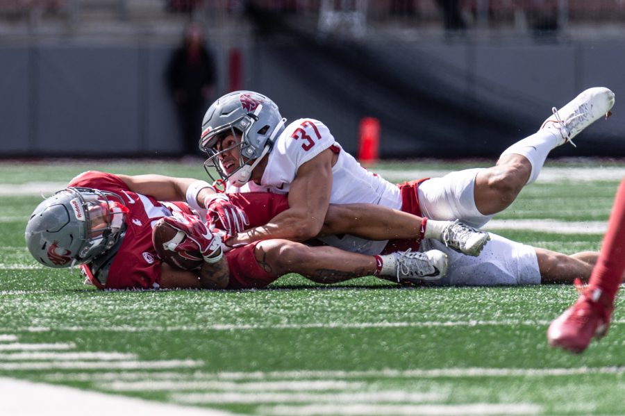 WSU defensive back Sam Lockett III tackles wide receiver Lincoln Victor during the 2022 Spring Game, April 23, at Martin Stadium.