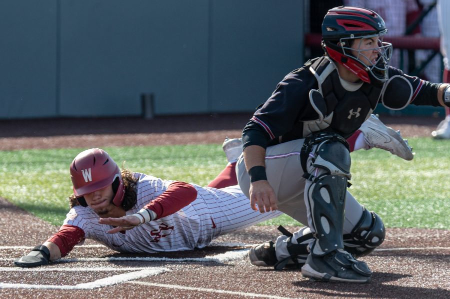WSU infielder Kyle Russell dives for home plate during an NCAA collegiate baseball game against Utah, April 1, at Bailey-Brayton Field.