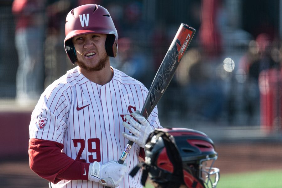 WSU outfielder Justin Van De Brake (right) talks with the umpire during an NCAA collegiate baseball game against Utah, April 1, at Bailey-Brayton Field.