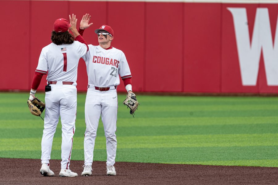 WSU infielders Kyle Russell (1) and Kodie Kolden (5) high five during an NCAA collegiate baseball game, April 2, at Bailey-Brayton Field.