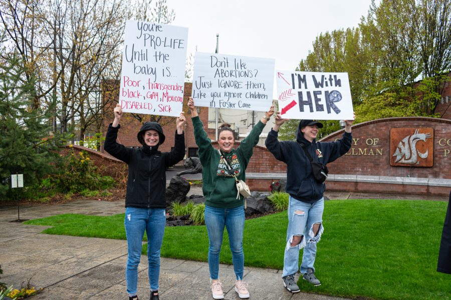 Claren Bolard, Britney Gough and Mary Hogan (left to right) raise their posters high as they join the Womens March Foundations Bans Off Our Bodies rally, May 14. 