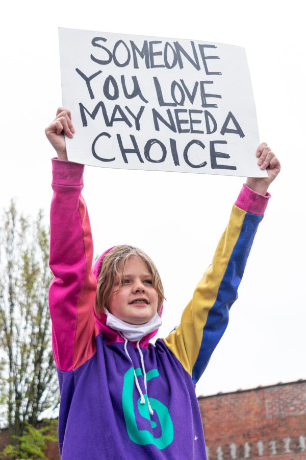 Isavan Kuiken holds her pro-choice poster high despite the rain at the Womens March Foundations Bans Off Our Bodies rally, May 14.  