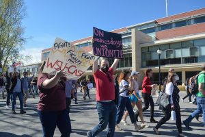 Academic student employees march toward WSU Pullmans French Administration Building to present their petition to the administration at a rally, May 4.