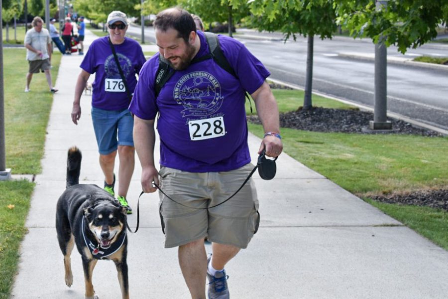 Dogs and owners gear up for a day of excercise and playtime at a previous Paw-Louse 5k Fun Run and Walk.