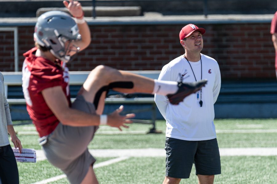 WSU head coach Jake Dickert tracks a punt by Nick Haberer during practice, Aug. 17, in Martin Stadium.