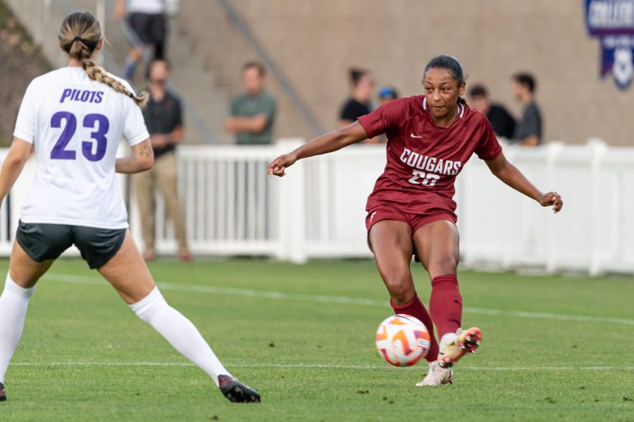 WSU defender Aaqila McLyn passes the ball during an NCAA womens soccer match against Portland, Aug. 25, at Lower Soccer Field.