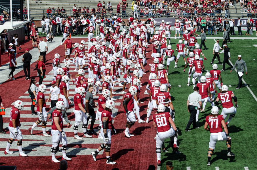 WSU players warm up before an NCAA football game against Colorado State, Sep. 17.
