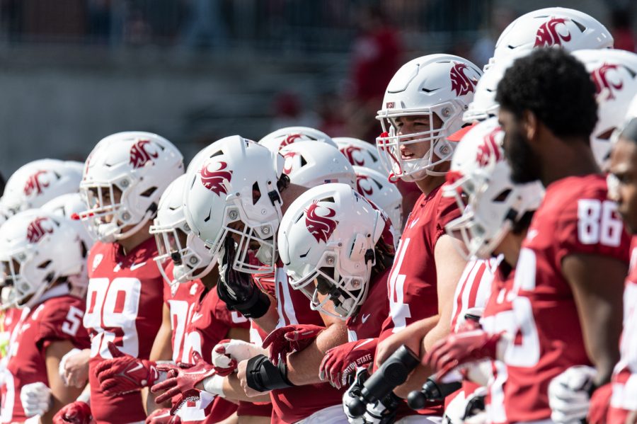 WSU players line up during the coin toss before an NCAA football game against Colorado State, Sep. 17.