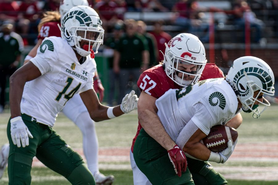 WSU linebacker Kyle Thornton (52) tackles a Colorado State player during an NCAA football game, Sep. 17.