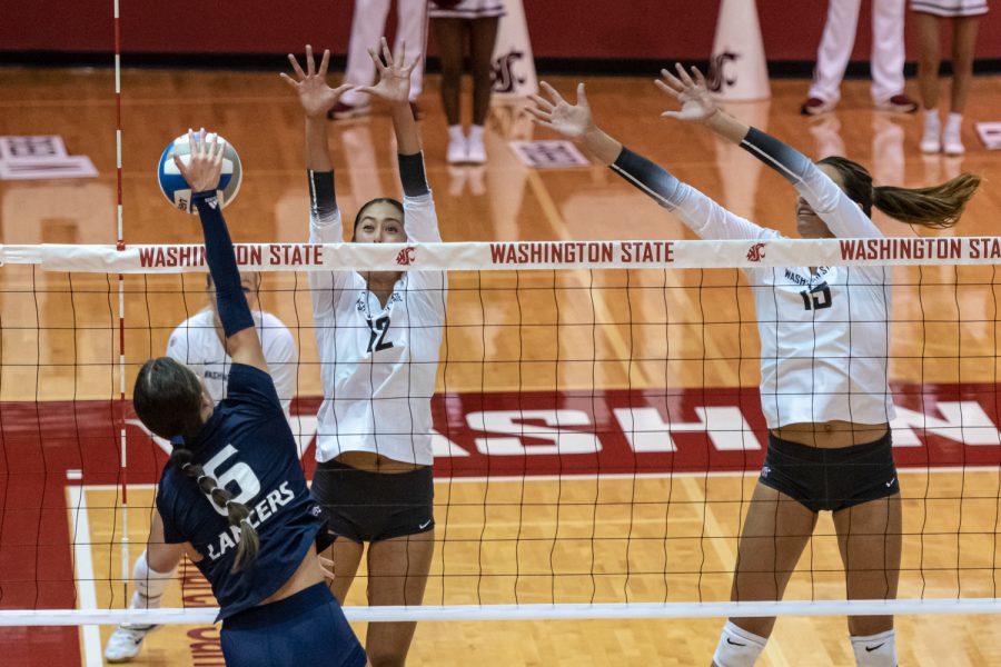 WSU setter Argentina Ung (12) and middle blocker Magda Jehlarova (15) attempt to block a spike from California Baptist outside hitter Mia Jerue (6) during an NCAA womens volleyball match, Sept. 1, at Bohler Gymnasium.