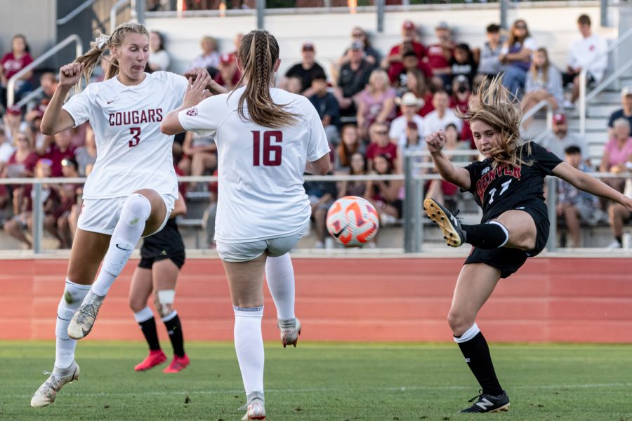 WSU midfielder Sydney Studer (3) attempts to block a Denver clearance during an NCAA womens soccer match, Sep. 5, at Lower Soccer Field.