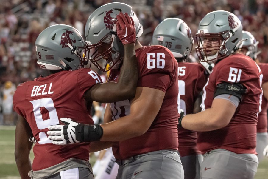 WSU wide receiver Renard Bell (9) and offensive lineman Maake Fifita (66) celebrate after a touchdown during an NCAA football match against Idaho, Sep. 3, at Martin Stadium.